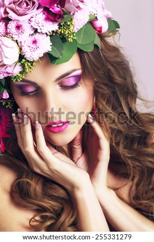Beautiful Girl With Different Flowers.Beauty Model Woman Face. Perfect Skin. Glamour style Fashion Portrait.