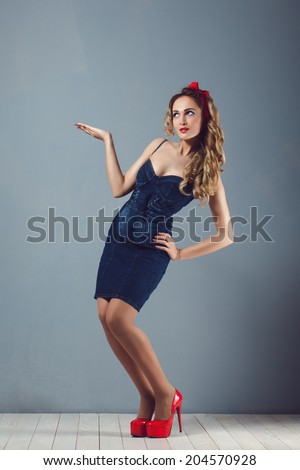 sexy blonde woman in jeans sundress and red shoes pin up girl retro woman sexy legs and a red capitiumon his head place your ad Wrap hair