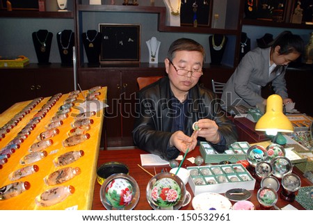 BEIJING, CHINA - MARCH 26: Chinese artist painting in art souvenir shop at March 26,2010 in Beijing, China