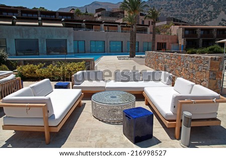 CRETE, GREECE - JULY 14, 2012: outdoor furniture on beautiful mediterranean patio in summer resort, Crete, Greece, wide angle image