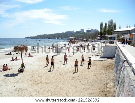 ODESSA, UKRAINE - MAY 3, 2010: Young people rest and play volleyball on the public sand beach Arcadia near Black Sea in Odessa, Ukraine.