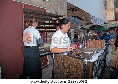 KIEV, UKRAINE - OCTOBER 11, 2014: Unidentified people cook and trades sweet rolls on food stall in Street Food Festival in Kiev, Ukraine.
