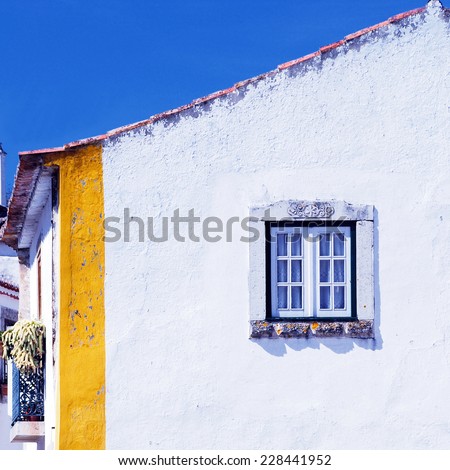 white wall and window in medieval european house, Obidos, Portugal, square image
