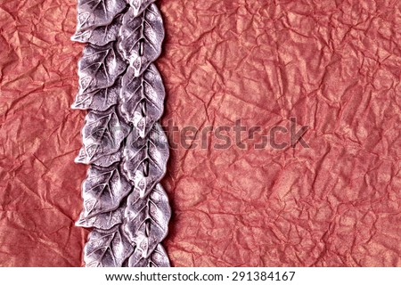 silver leaves ornament on gold crumpled tissue paper texture for background