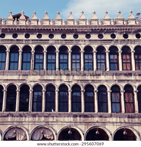 Medieval gallery facade with arch windows on Piazza San Marco (Saint Mark square) in Venice, Italy. Square toned image, instagram effect