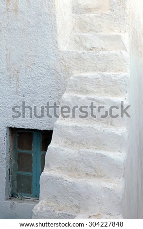 The window and old white stairs of Santorini traditional house, Oia, Greece