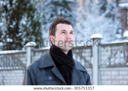 romantic sweet man is delighted on the street in winter