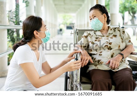 Similar – Image, Stock Photo old woman wearing protective mask holding hands with unrecognizable woman. New normal concept