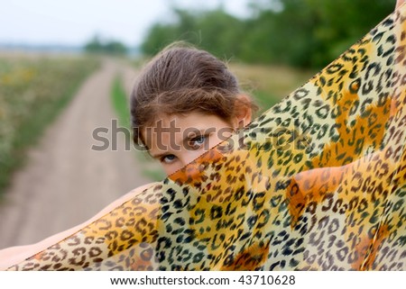 Lovely girl with fabric on road outdoor
