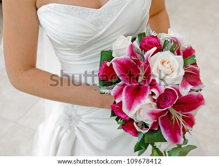 Bride holding wedding bouquet.