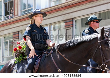 Portland, Oregon, USA - JUNE 7, 2014: Portland Police Mounted Patrol  in Grand floral parade through Portland downtown.