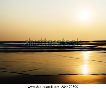 Horizontal vivid sunset ocean horizon tidal waves blur landscape background backdrop