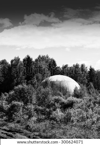 Vertical vibrant black and white extraterrestrial ufo sphere saucer in woods background backdrop