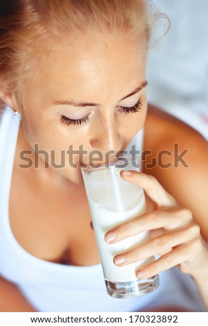 woman drinking milk, indoors