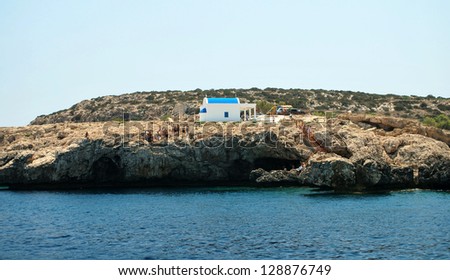 People visit small Orthodox chapel on the rocks of Mediterranean coast,Cyprus