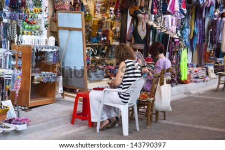 NIKOSIA,NORTHERN CYPRUS-JUNE 10:Tourists have a chance to watch, how local women,made jewelry from stones, beads and leather and to buy them in Nicosia, Northern Cyprus on june 10,2013