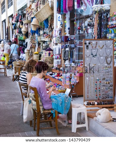 NIKOSIA,NORTHERN CYPRUS-JUNE 10,2013:Tourists have a chance to watch, how local women,made jewelry from stones, beads and leather and to buy them in Nicosia, Northern Cyprus on june 10,2013