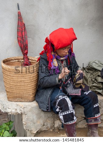 SAPA DISTRICT, VIETNAM - JANUARY 18: An unidentified woman works on a traditional embroidery on January 18, 2008 in Sapa, Vietnam. Sapa is home to a great diversity of ethnic minorities of Vietnam.