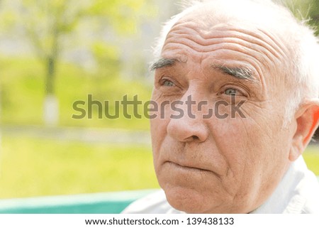 Close up portrait of an old man over the blurred background