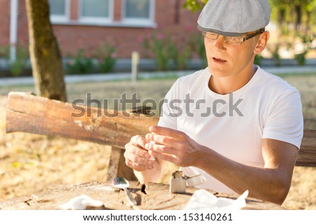 Addicted man preparing the next dose of heroin in order to inject it intravenously