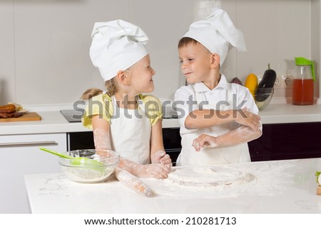 Adorable Little Chefs Very Happy Playing at Kitchen Area