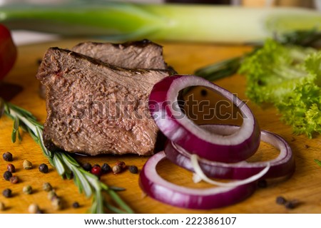 Sliced Beef and Red Onions on Chopping Board with Other Ingredients