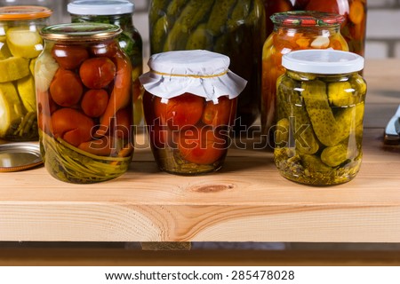 Variety of Jars of Pickled Vegetables on Wooden Table, Selection of Preserved Vegetables For Sale at Farmers Market