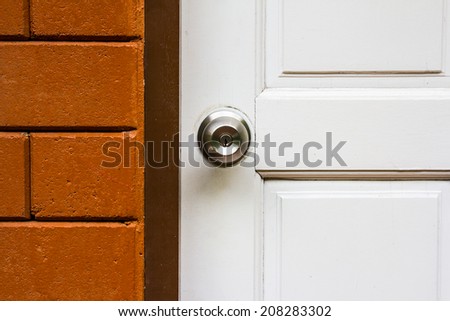 Aluminum door knob on the white door