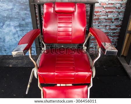 vintage barber chair over brick wall