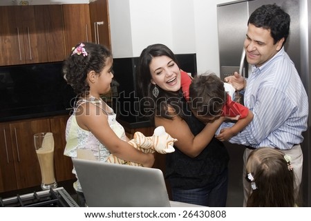 Portrait of beautiful family playing in kitchen, dad, mom, daughters and little boy