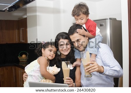 Portrait of beautiful family cooking in kitchen, dad, mom and little daughter