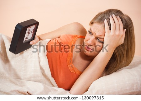 Young woman awaking up after over-sleeping,Waking up
