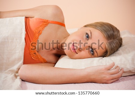 Portrait of  beautiful woman lying on bed,Young woman lying on bed