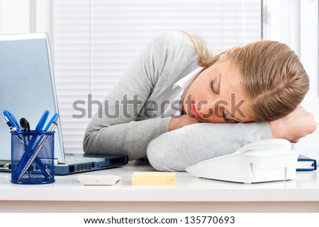 Tired businesswoman sleeping at work,Tired businesswoman