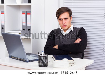 Portrait of  angry businessman sitting in her office,Angry businessman
