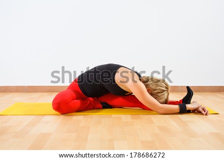 Young woman practicing yoga,Janu Sirsasana/Head-to-Knee Forward Bend