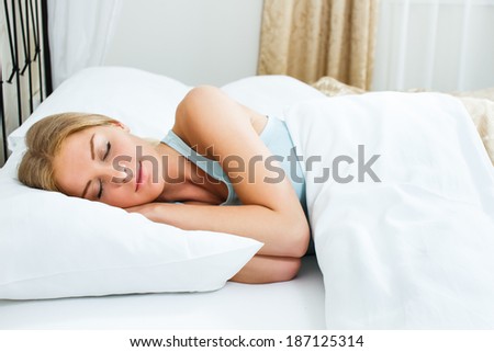 Beautiful blonde woman is sleeping in her bedroom,Woman sleeping
