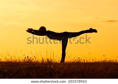 A silhouette of a woman practicing yoga,Yoga-Virabhadrasana III /Warrior Pose III
