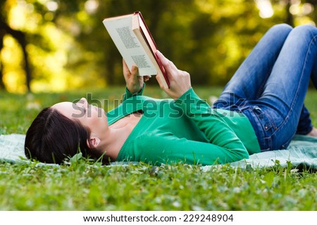 Woman is reading a book and enjoys in her free time,Leisure time