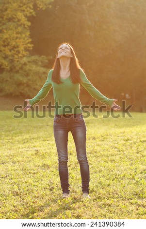 Beautiful young woman enjoys in nature.Peace of mind in nature