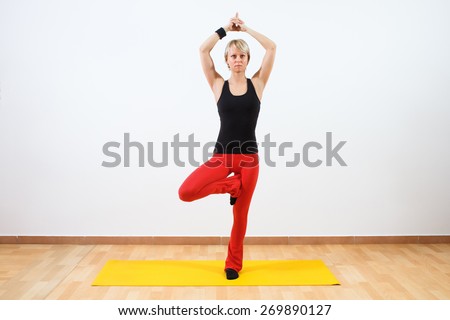 Young woman practicing yoga. Yoga-Tree pose/Vrikshasana