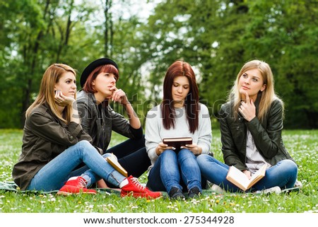 Young girls sitting in the park and thinking.Students