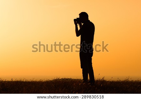 Silhouette of a man photographing.Man photographing