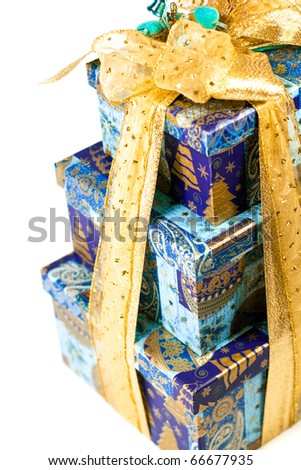 pyramid of blue gift boxes with golden bow closeup on white background