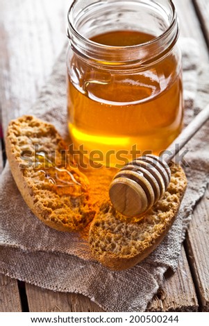 crackers and honey on rustic wooden board
