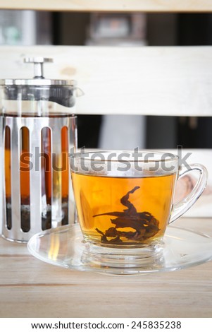 Hot tea with tea pot on table