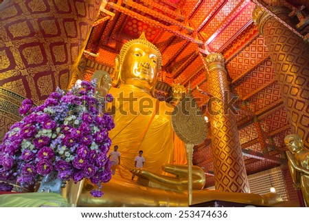 AYUTTHAYA, THAILAND - Febbuary 16: People work with cloth on Buddha image in Wat Phanan Choeng temple on Febbuary 16, 2015 in Ayutthaya, Thailand. Ayutthaya is former capital of Siam (former Thailand)