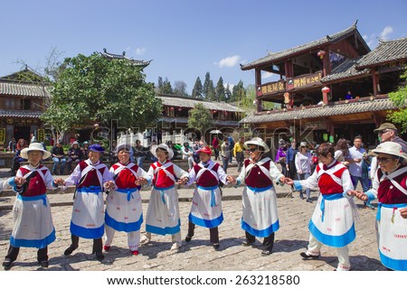 LIJIANG,CHINA-MARCH 20: The people Naxi nationality old woman of traditional dance on March 20,2015 in Dayan Old Town of Lijiang ,Yunnan Province in China.The Lijiang is a tourist city of China.