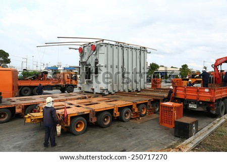 AYUTTHAYA -THAILAND - JANUARY 8 : The workers transported a large old transformer at Gas station, January 8, 2014 in Ayutthaya province, Thailand