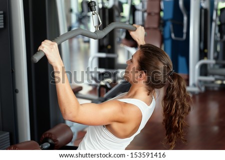 Young woman exercising in health club
